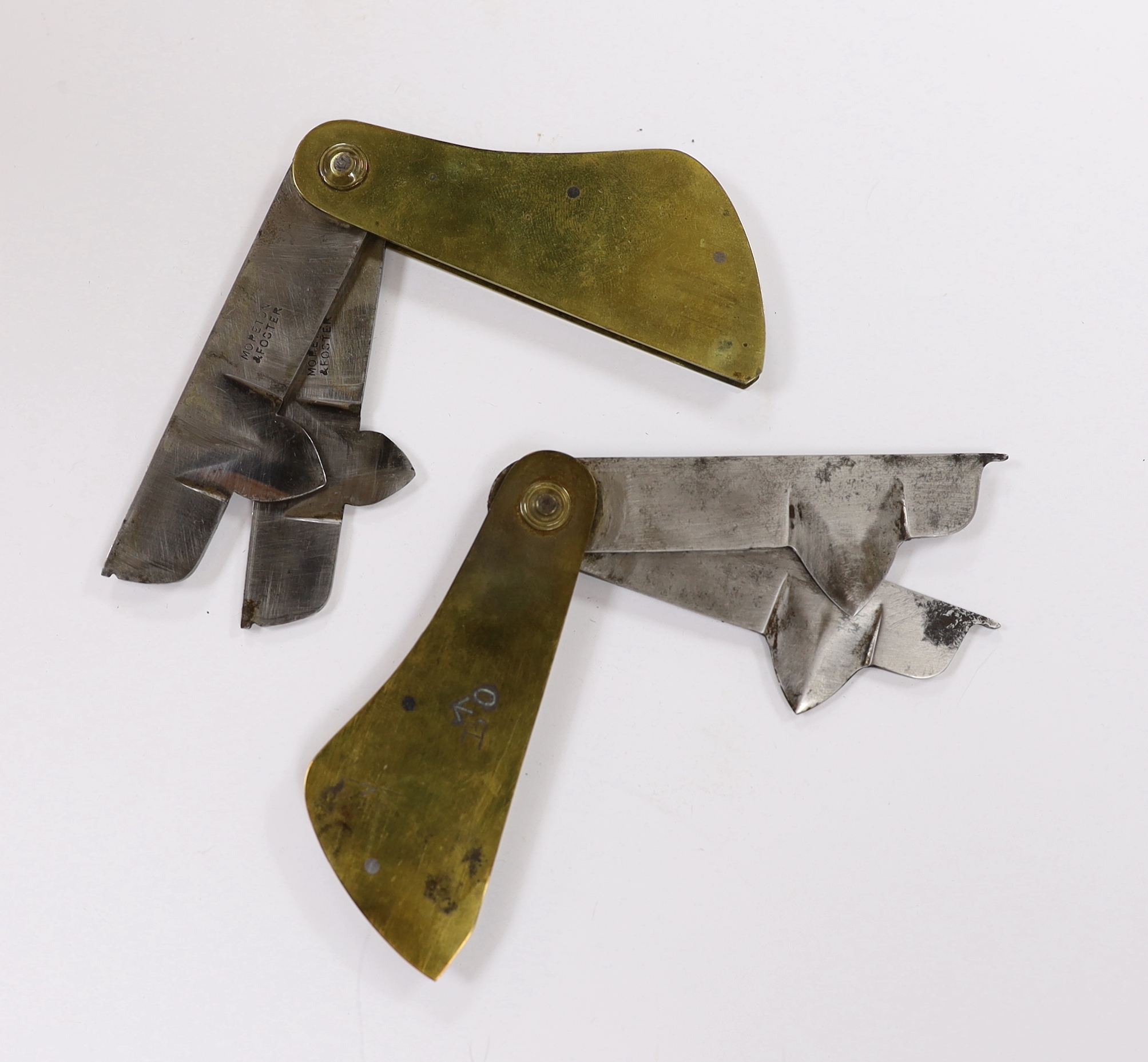 Two Georgian leather cased brass and steel fleams, one stamped ‘W&H Hutchinson Sheffield’ and the other ‘Morton & Foster’, both engraved with early military broad arrow, cases 11cm